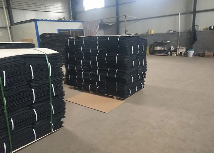 Bundled black oyster mesh rolls stored in a production area